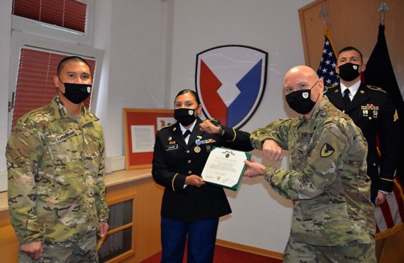 Spc. Christine Cristino, center, is pictured with Col. Shane Roach, right, commander of the U.S. Army Medical Materiel Center-Europe, and Sgt. Maj. Francis Famularcano after being recognized as USAMMC-E’s Soldier of the Quarter.