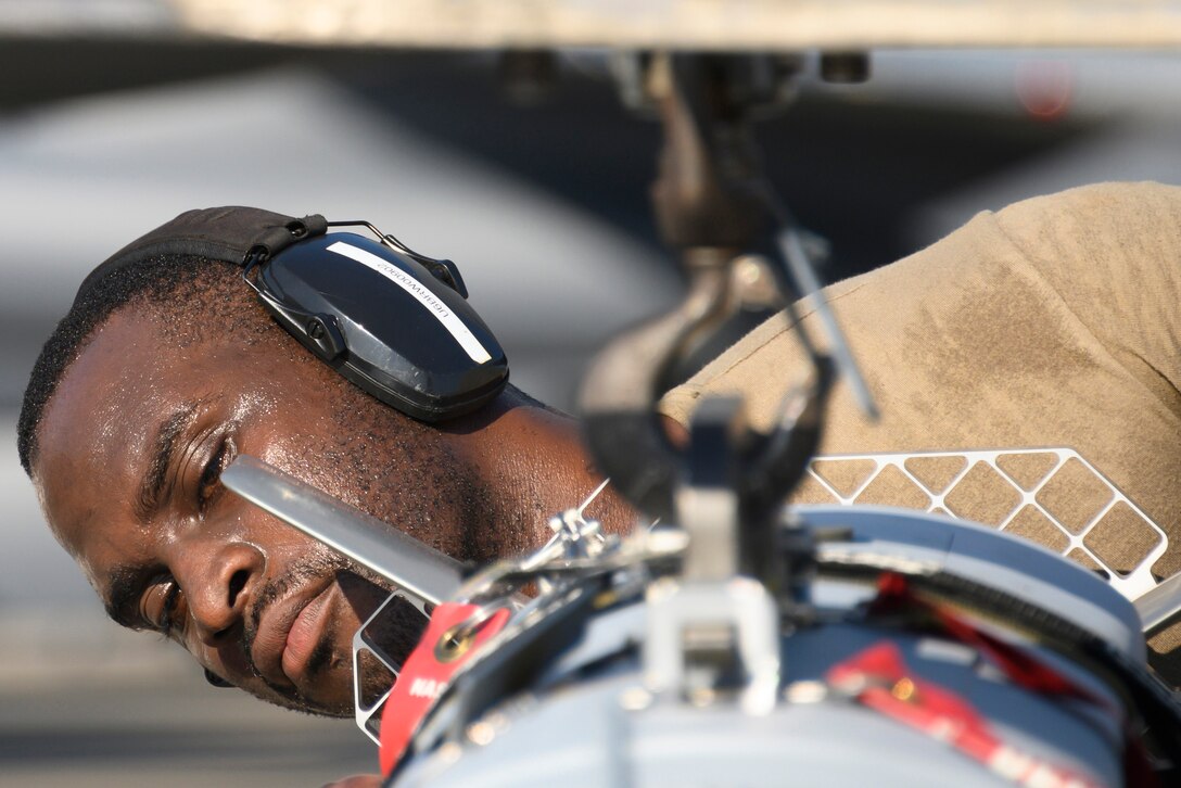 An airman loads a munition.
