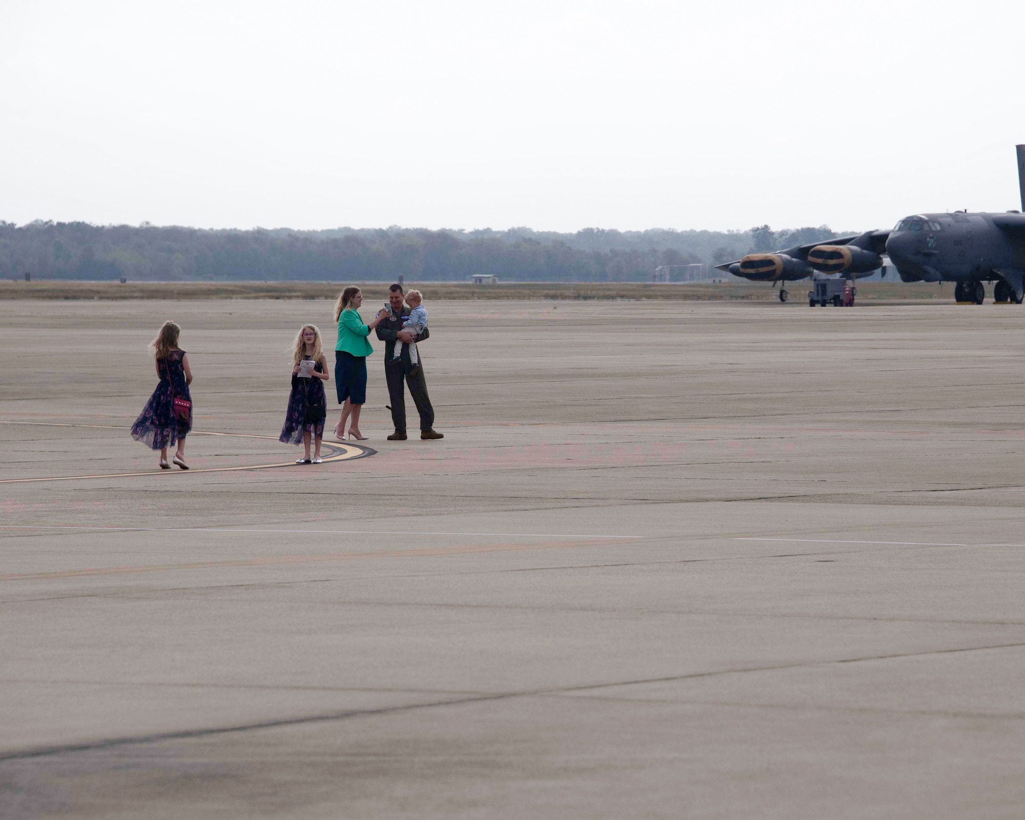 A family walks on the flight line.