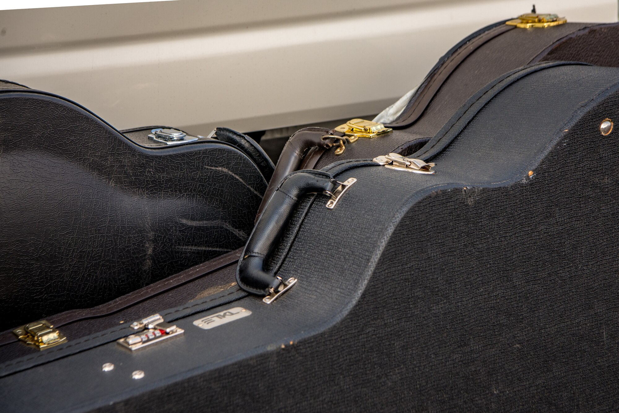 guitar cases lay on their sides