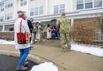 World War II veteran Lenny Roberge, Vermont’s oldest living veteran, prepares to hand out to Airmen present apple pie he baked in appreciation for receiving a flag flown in the F-35, at a small ceremony outside his nursing home in South Burlington, Vt., Dec. 22, 2020. In order to honor Roberge, Airmen from the 158th Fighter Wing had a flag flown in an F-35 during a combat training sortie over the mountains of Vermont and New York. (U.S. Air National Guard photo by Senior Master Sgt. Michael Davis)