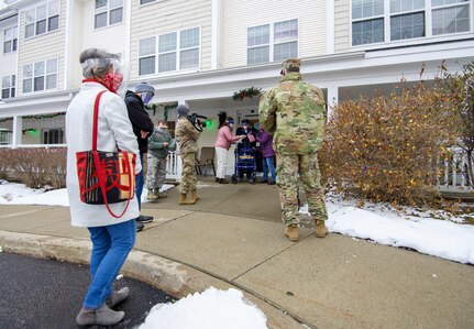 World War II veteran Lenny Roberge, Vermont’s oldest living veteran, prepares to hand out to Airmen present apple pie he baked in appreciation for receiving a flag flown in the F-35, at a small ceremony outside his nursing home in South Burlington, Vt., Dec. 22, 2020. In order to honor Roberge, Airmen from the 158th Fighter Wing had a flag flown in an F-35 during a combat training sortie over the mountains of Vermont and New York. (U.S. Air National Guard photo by Senior Master Sgt. Michael Davis)