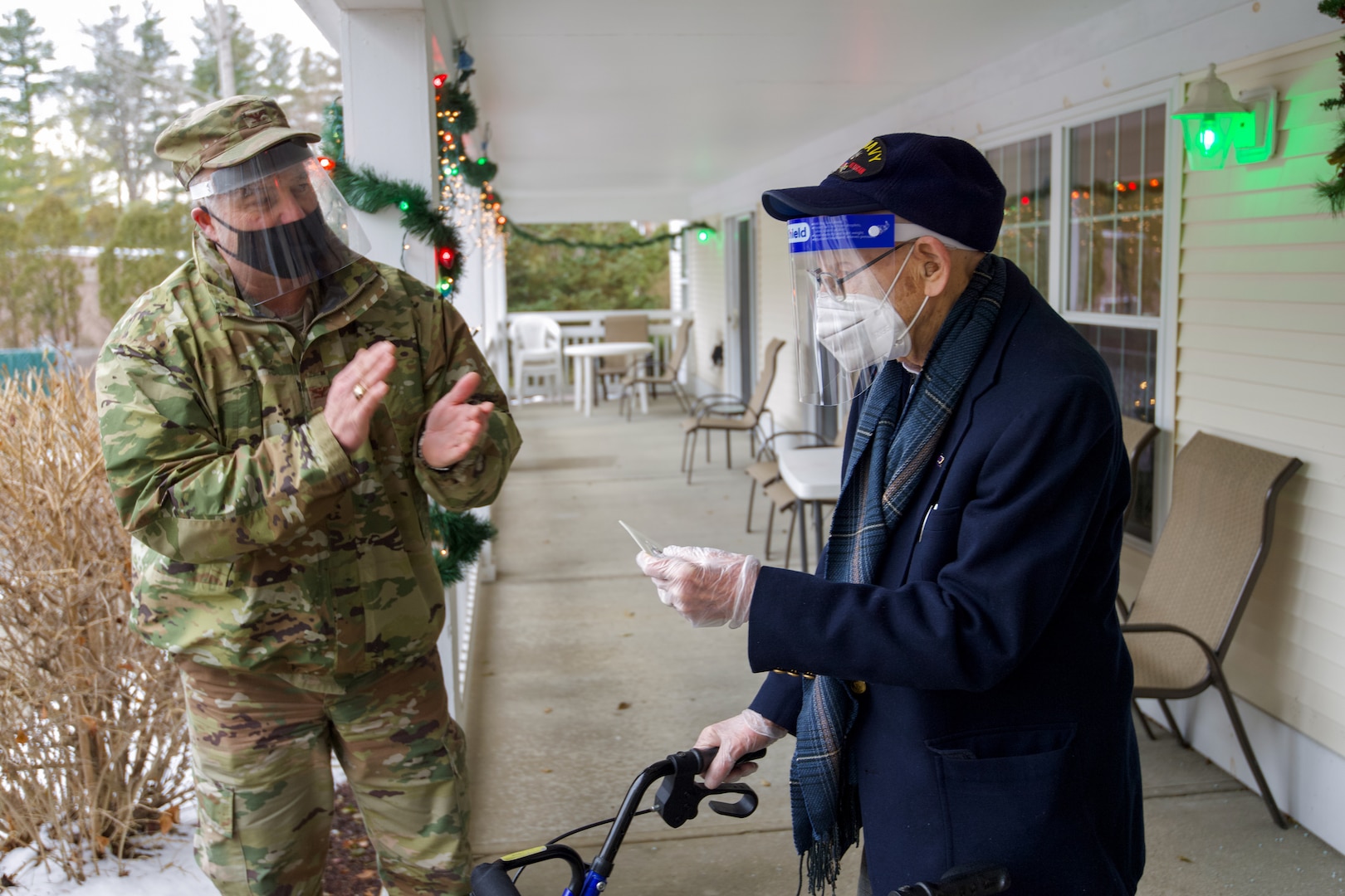 Col. Adam Rice (left), vice wing commander of the 158th Fighter Wing, Vermont Air National Guard, thanks WWII veteran Lenny Roberge, Vermont’s oldest living veteran, for his military service at a small ceremony in South Burlington, Vt., Dec. 22, 2020. In order to honor Roberge, Airmen from the 158th Fighter Wing had a flag flown in an F-35 during a combat training sortie over the mountains of Vermont and New York. (U.S. Air National Guard photo by Senior Master Sgt. Michael Davis)