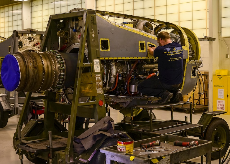 Contract Field Team member, Jack Mason, assembles a refurbished T-56 engine on an engine stand prior to final testing and inspection, Dec. 29, 2020, at Little Rock Air Force Base, Ark. The facility produces all C-130H Hercules T-56 3.5 modified engine and 54H60-117 propeller overhauls for Air Force Reserve Command and various Air National Guard units. (U.S. Air Force Reserve photo by Maj. Ashley Walker)
