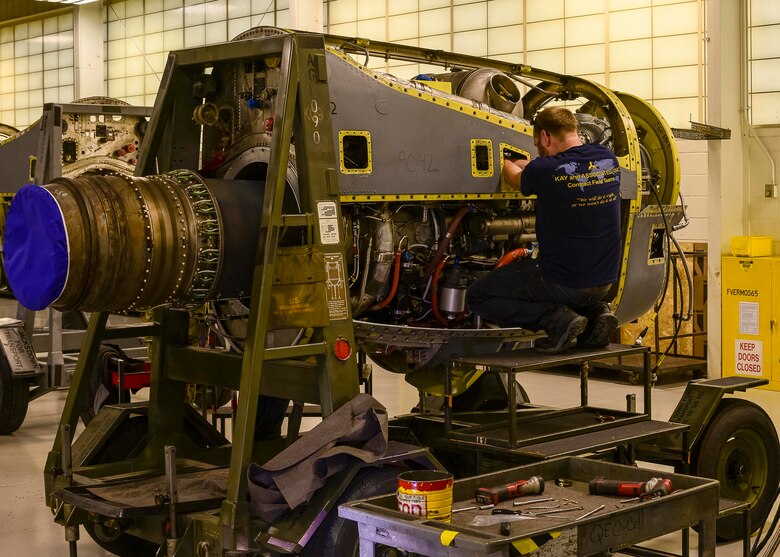 Contract Field Team member, Jack Mason, assembles a refurbished T-56 engine on an engine stand prior to final testing and inspection, Dec. 29, 2020, at Little Rock Air Force Base, Ark. The facility produces all C-130H Hercules T-56 3.5 modified engine and 54H60-117 propeller overhauls for Air Force Reserve Command and various Air National Guard units. (U.S. Air Force Reserve photo by Maj. Ashley Walker)