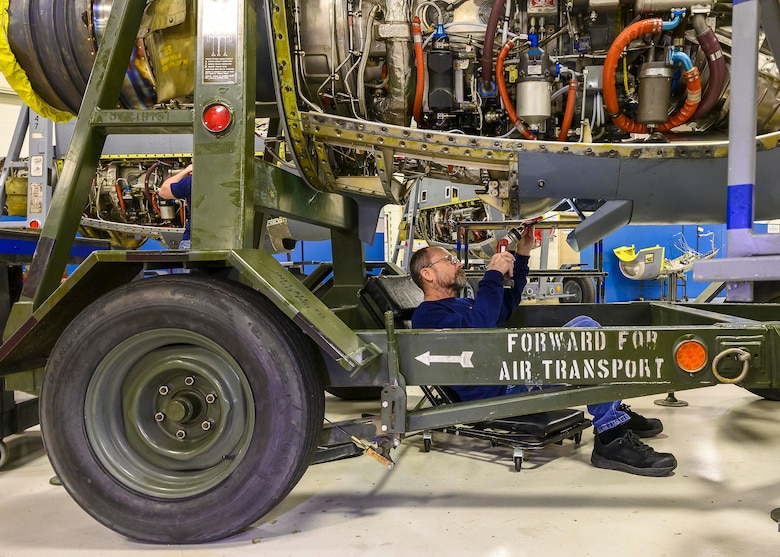 Stan Gonyea, a Contract Field Team member, inspects the lower portion of the engine, Dec. 29, 2020, at Little Rock Air Force Base, Ark. The facility produces all C-130H Hercules T-56 3.5 modified engine and 54H60-117 propeller overhauls for Air Force Reserve Command and various Air National Guard units. After streamlining the repair process in 2001 to mimic an assembly line, the facility averages 12-16 days, or 2 days per each section to completely overhaul one engine. (U.S. Air Force Reserve photo by Maj. Ashley Walker)
