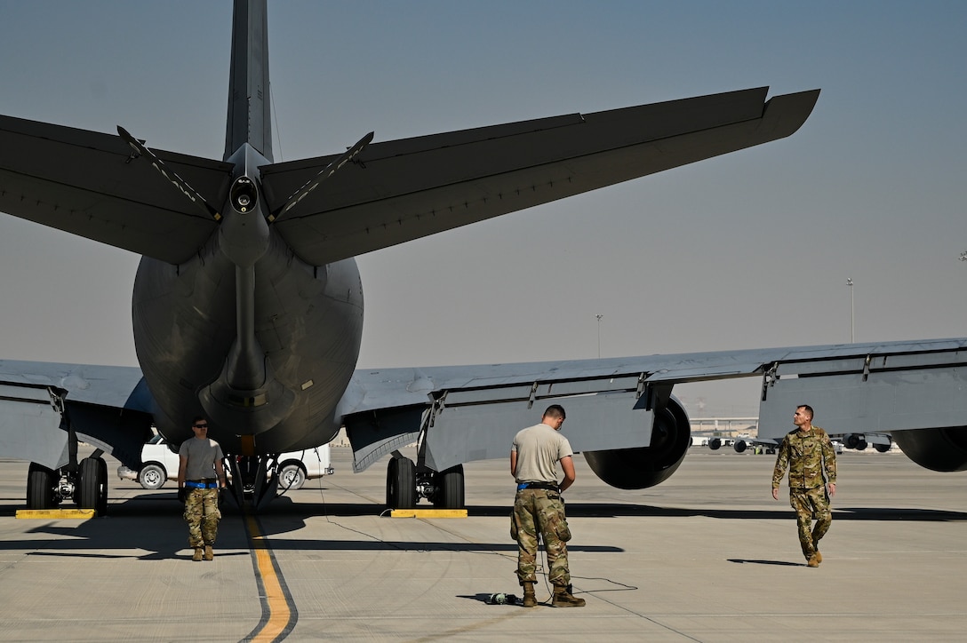 A U.S. Air Force KC-135 Stratotanker pilot with the 28th Expeditionary Air Refueling Squadron, right, and two crew chiefs with the 385th Expeditionary Aircraft Maintenance Squadron conduct a preflight walk-around inspection at Al Udeid Air Base, Qatar, Jan. 17, 2020.