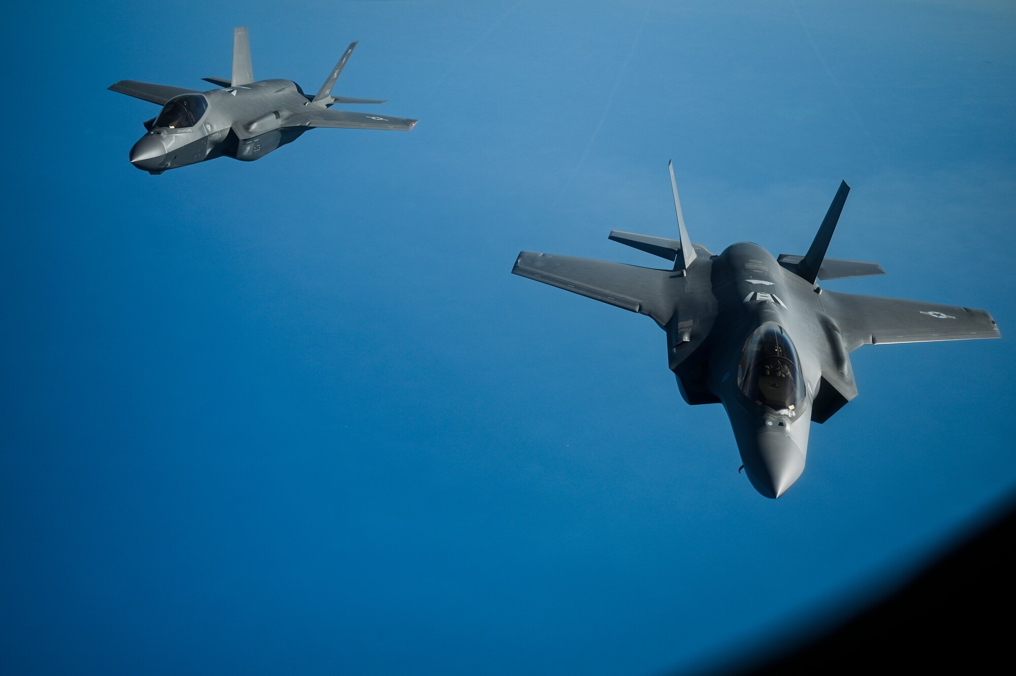 Two U.S. Air Force F-35A Lighting II's fly over the Arabian Gulf during an in-air refueling mission with a U.S. Air Force KC-135 Stratotanker assigned to the 28th Expeditionary Air Refueling Squadron, deployed to Al Udeid Air Base, Qatar, Jan. 17, 2020.