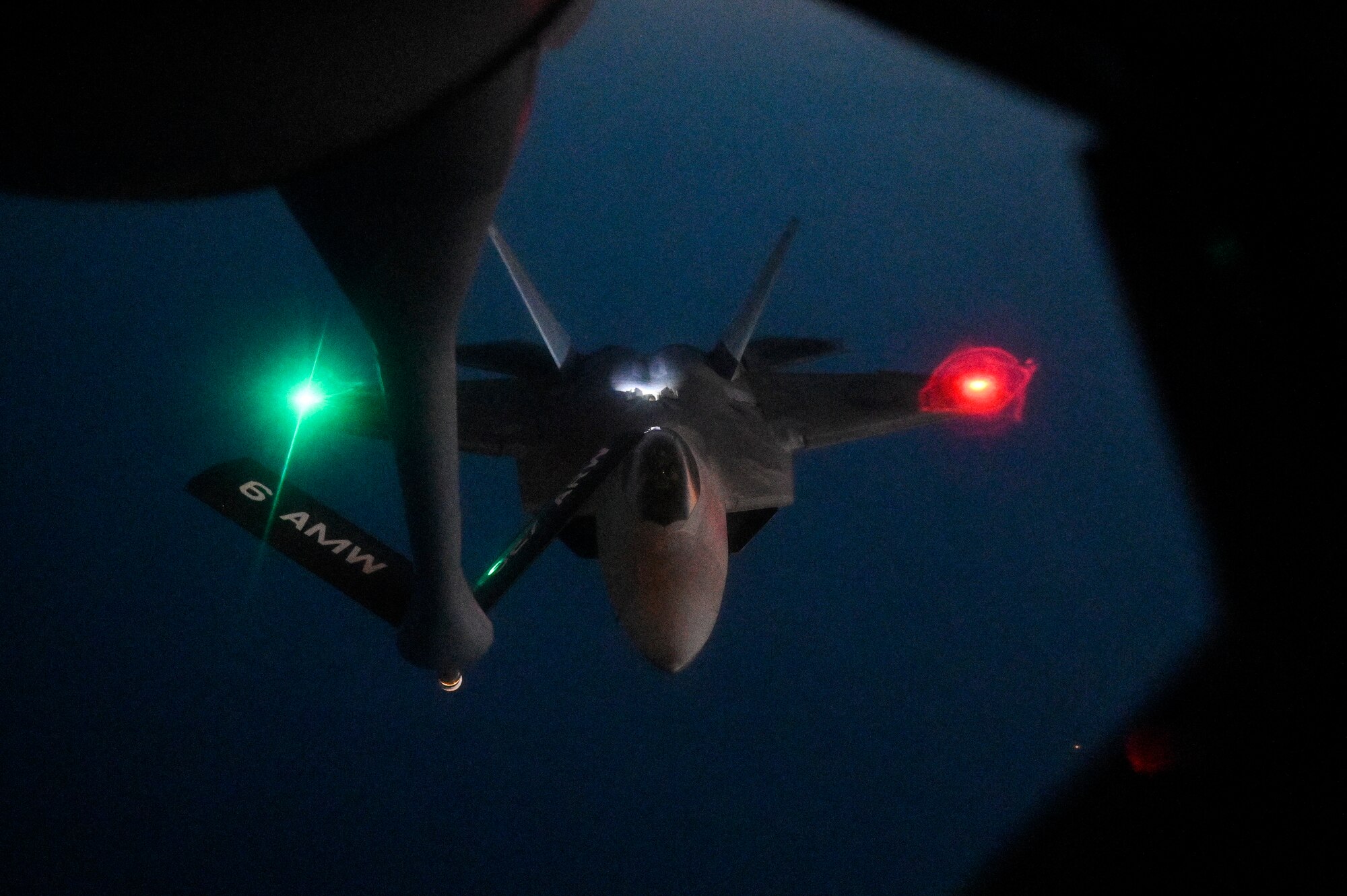 A U.S. Air Force F-22 Raptor approaches the boom of a U.S. Air Force KC-135 Stratotanker assigned to the 28th Expeditionary Air Refueling Squadron, deployed to Al Udeid Air Base, Qatar, to conduct an in-air refueling mission WHERE, Jan. 17, 2020.
