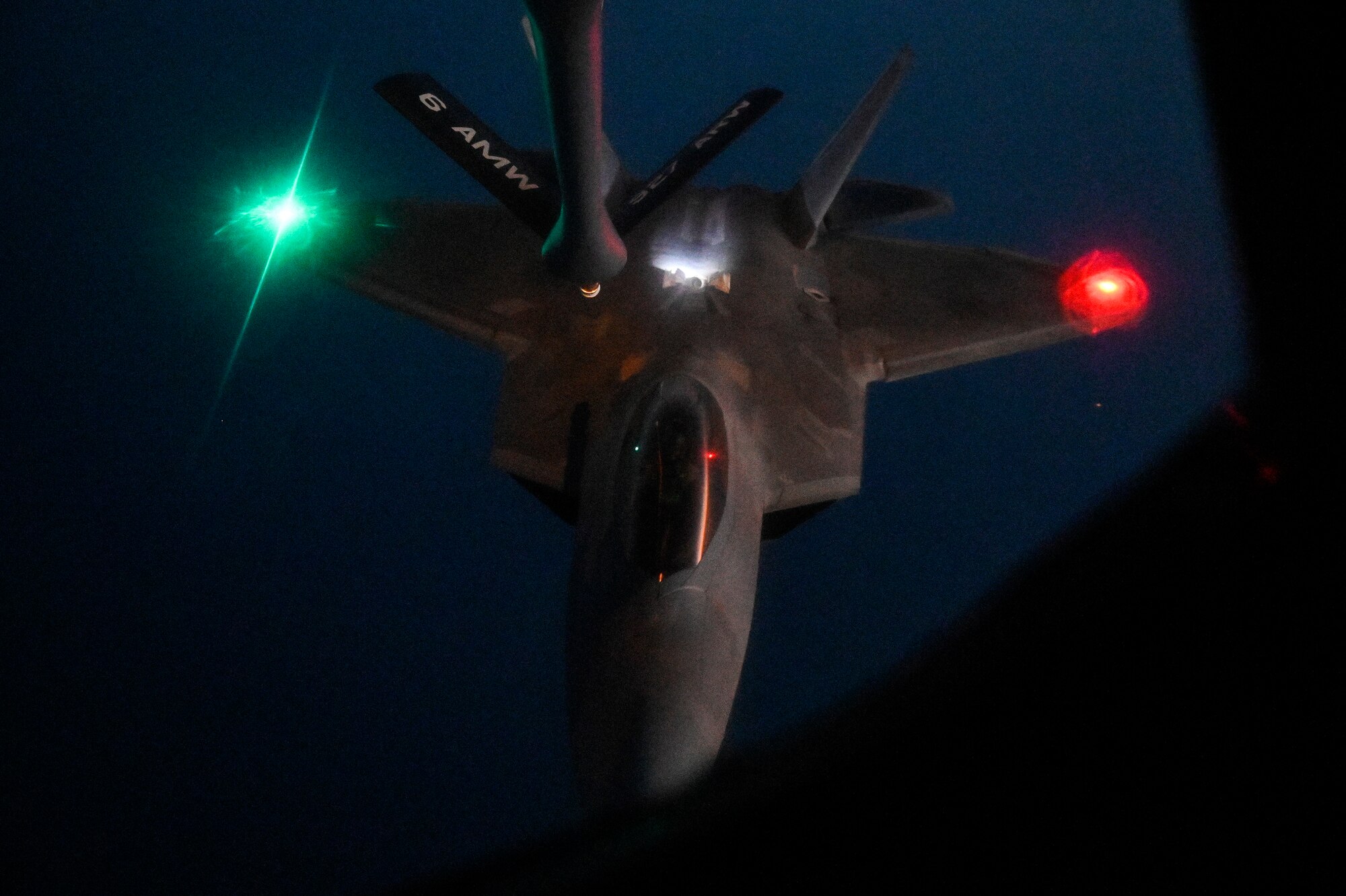 A U.S. Air Force F-22 Raptor approaches the boom of a U.S. Air Force KC-135 Stratotanker assigned to the 28th Expeditionary Air Refueling Squadron, deployed to Al Udeid Air Base, Qatar, to conduct an in-air refueling mission WHERE, Jan. 17, 2020.