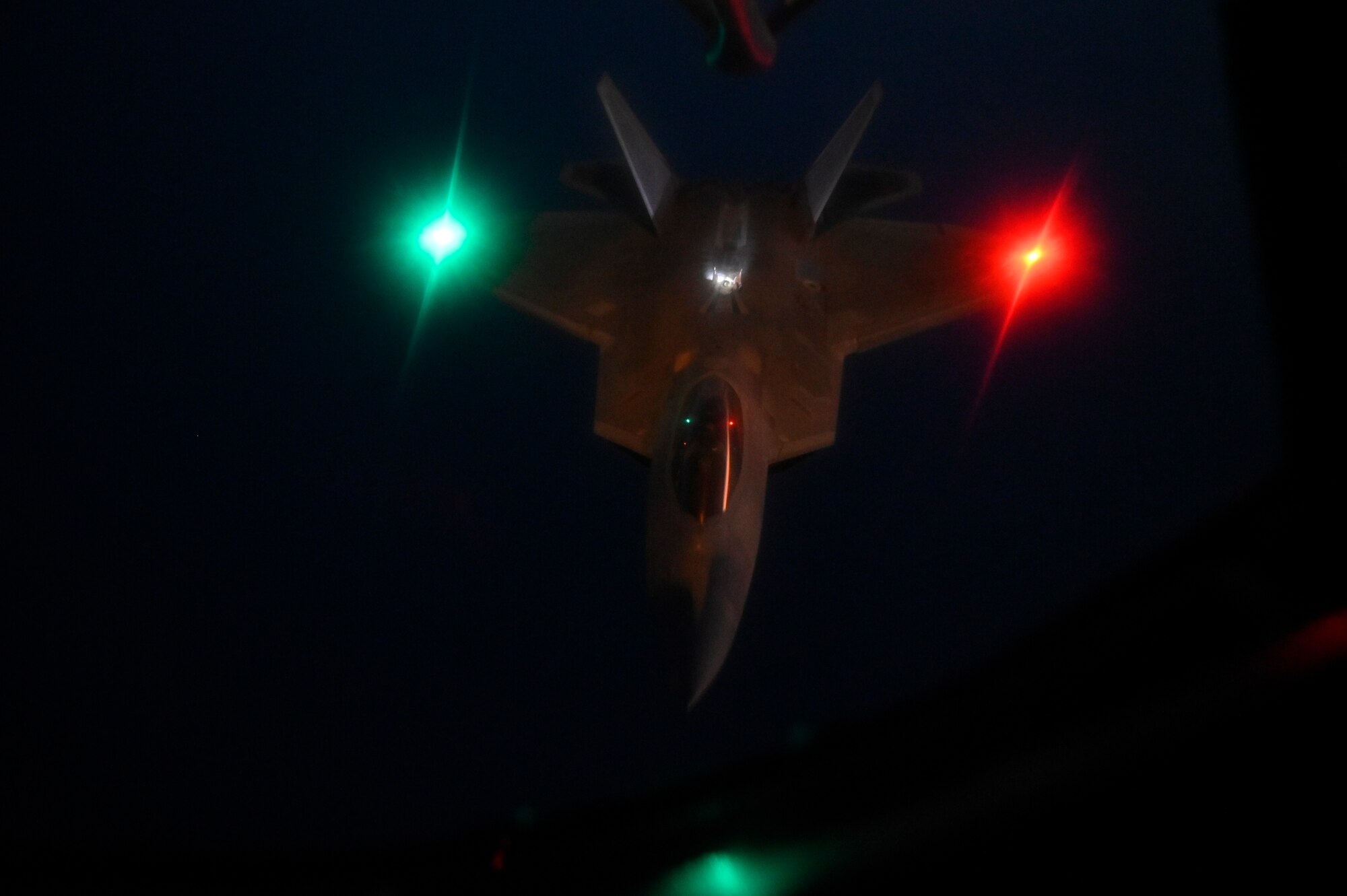 A U.S. Air Force F-22 Raptor flies over the Arabian Gulf during an in-air refueling mission with a U.S. Air Force KC-135 Stratotanker assigned to the 28th Expeditionary Air Refueling Squadron, deployed to Al Udeid Air Base, Qatar, Jan. 17, 2020.