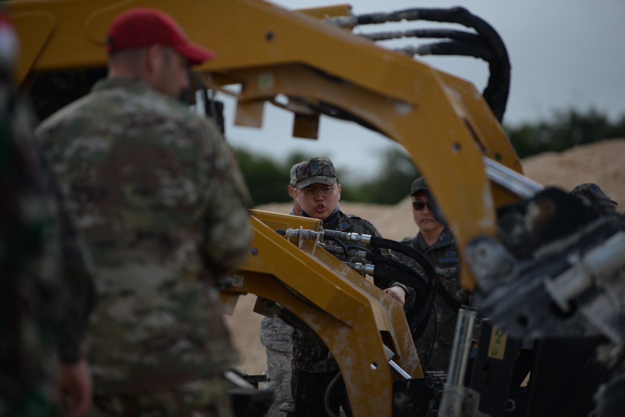 A Republic of Korea Air Force member instructs his team on using heavy duty equipment during exercise Silver Flag Jan. 29, 2020 at Andersen Air Force Base, Guam.