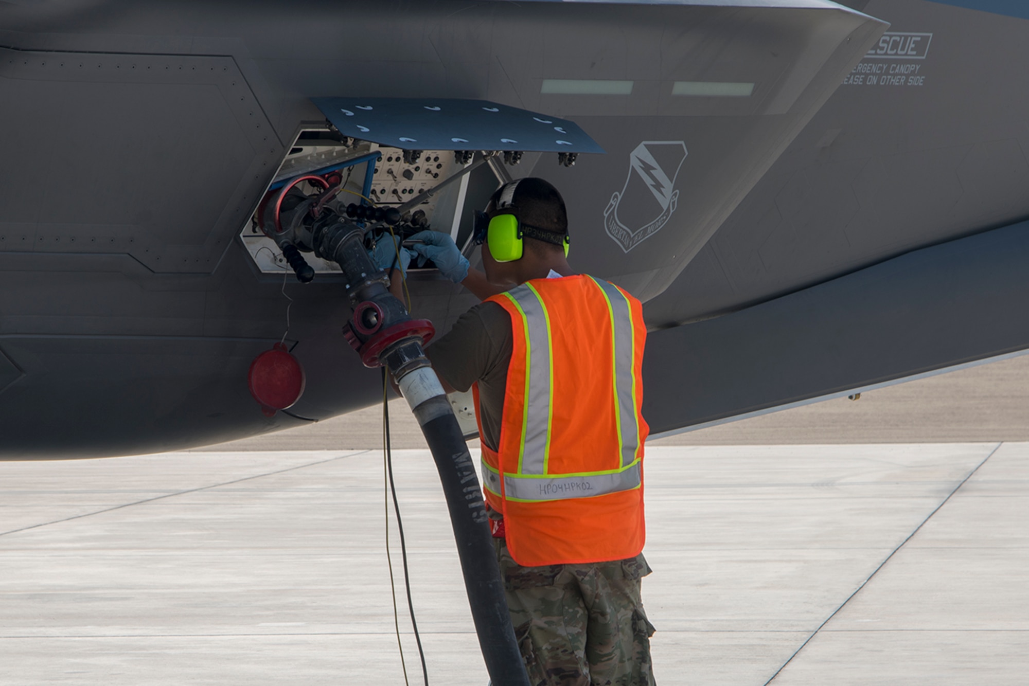 U.S. Air Force Staff Sgt. Kurt Anderson, 380th Air Expeditionary Aircraft Maintenance Squadron avionics journeyman, executes a hot pit refueling of an F-35A Lightning II on the Al Dhafra Air Base flightline, United Arab Emirates, Jan. 29, 2020.  A hot pit refueling is the process in which ground crew Airmen refuel an aircraft while its engines are still running, minimizing the time required to get the aircraft airborne again. This is the first-time that an F-35 has been hot-pit refueled at Al Dhafra Air Base. (U.S. Air Force photo by Staff Sgt. Anna-kay Ellis)