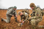 Senior Master Sgt. Bradley Rose, 185th Security Forces Squadron, left, Staff Sgt. Jonathan Finer, 124th SFS, and Master Sgt. Gregory Wardle, 153rd SFS, tackle a land navigation element Jan. 23, 2020, at Fort Chaffee, Arkansas. The team of Airmen from across the Air National Guard gathered to train for the Air Force Defender Challenge, a security forces skills competition held in May at Joint Base San Antonio-Camp Bullis, Texas.