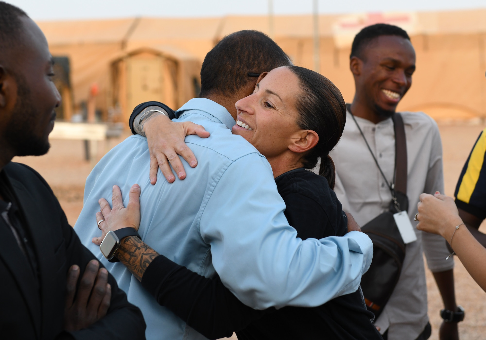 A member of the local English Discussion Group greets U.S. Army Capt. AnnaMaria Verdura, 443rd Civil Affairs Battalion Civil Affairs Team 219 team lead, during a meeting with U.S. military personnel at Nigerien Air Base 201, Niger, Feb. 1, 2020. Invited on base by members of the Civil Affairs Team, the group continually improves their language skills by talking to native English speakers. (U.S. Air Force photo by Tech. Sgt. Alex Fox Echols III) (This photo has been altered for security purposes by blurring out identification badges.)