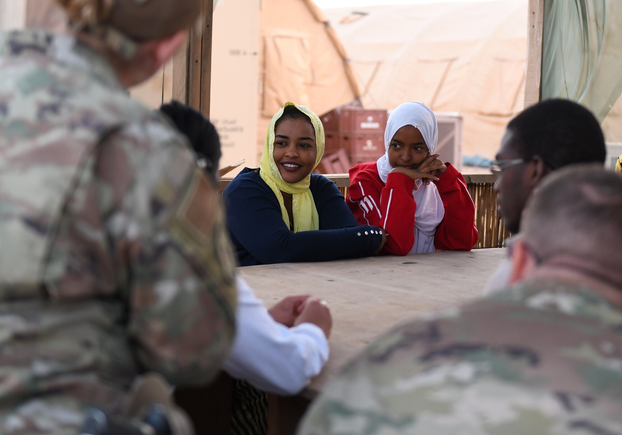 Members of the local English Discussion Group talk with U.S. military personnel at Nigerien Air Base 201, Niger, Feb. 1, 2020. Invited on base by members of the U.S. Army 443rd Civil Affairs Battalion Civil Affairs Team 219, the group continually improves their language skills by talking to native English speakers. (U.S. Air Force photo by Tech. Sgt. Alex Fox Echols III)