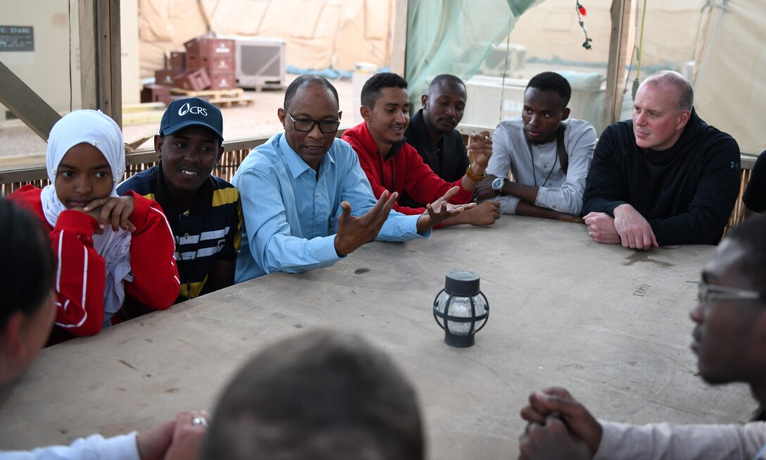 Members of the local English Discussion Group talk with U.S. military personnel at Nigerien Air Base 201, Niger, Feb. 1, 2020. Invited on base by members of the U.S. Army 443rd Civil Affairs Battalion Civil Affairs Team 219, the group continually improves their language skills by talking to native English speakers. (U.S. Air Force photo by Tech. Sgt. Alex Fox Echols III)
