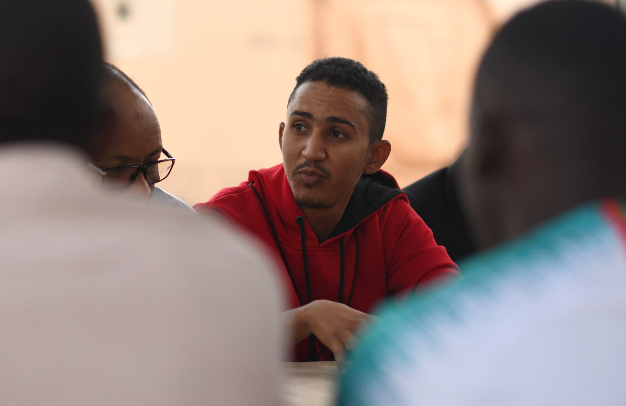 A member of the local English Discussion Group talks with U.S. military personnel at Nigerien Air Base 201, Niger, Feb. 1, 2020. Invited on base by members of the U.S. Army 443rd Civil Affairs Battalion Civil Affairs Team 219, the group continually improves their language skills by talking to native English speakers. (U.S. Air Force photo by Tech. Sgt. Alex Fox Echols III)