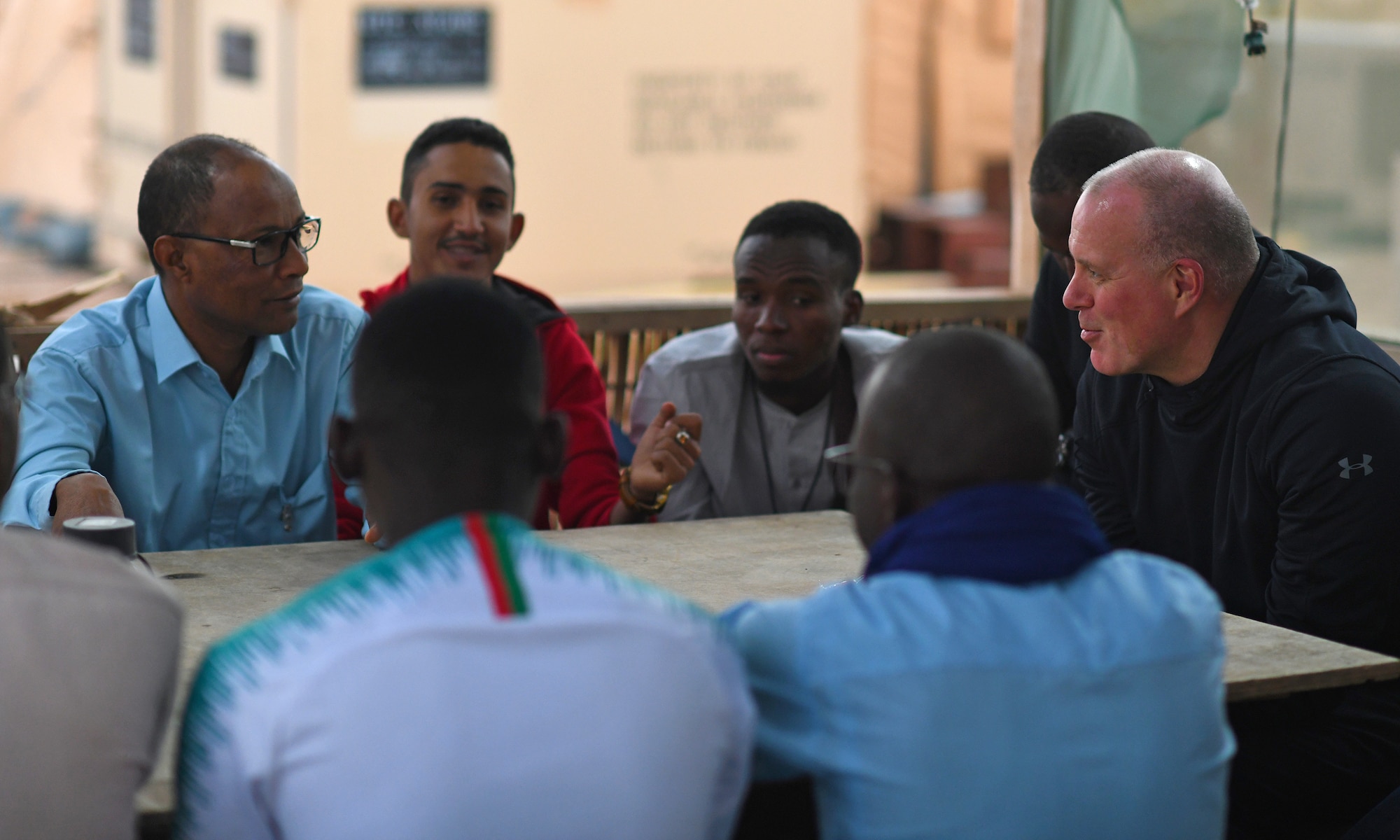 Members of the local English Discussion Group talk with U.S. military personnel at Nigerien Air Base 201, Niger, Feb. 1, 2020. Invited on base by members of the U.S. Army 443rd Civil Affairs Battalion Civil Affairs Team 219, the group continually improves their language skills by talking to native English speakers. (U.S. Air Force photo by Tech. Sgt. Alex Fox Echols III)