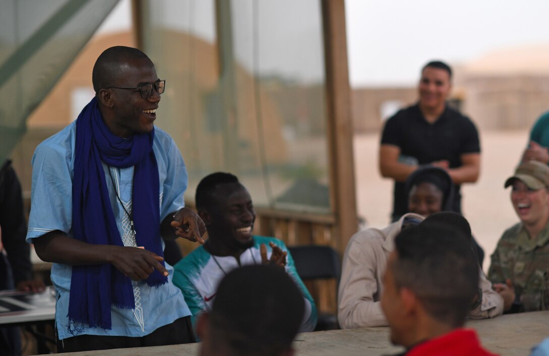 A member of the local English Discussion Group sings during a meeting with U.S. military personnel at Nigerien Air Base 201, Niger, Feb. 1, 2020. Invited on base by members of the U.S. Army 443rd Civil Affairs Battalion Civil Affairs Team 219, the group continually improves their language skills by talking to native English speakers. (U.S. Air Force photo by Tech. Sgt. Alex Fox Echols III)
