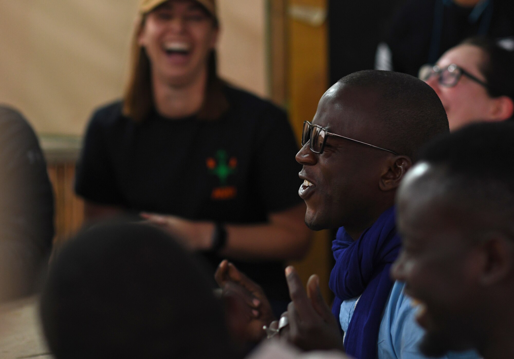 A member of the local English Discussion Group sings during a meeting with U.S. military personnel at Nigerien Air Base 201, Niger, Feb. 1, 2020. Invited on base by members of the U.S. Army 443rd Civil Affairs Battalion Civil Affairs Team 219, the group continually improves their language skills by talking to native English speakers. (U.S. Air Force photo by Tech. Sgt. Alex Fox Echols III)