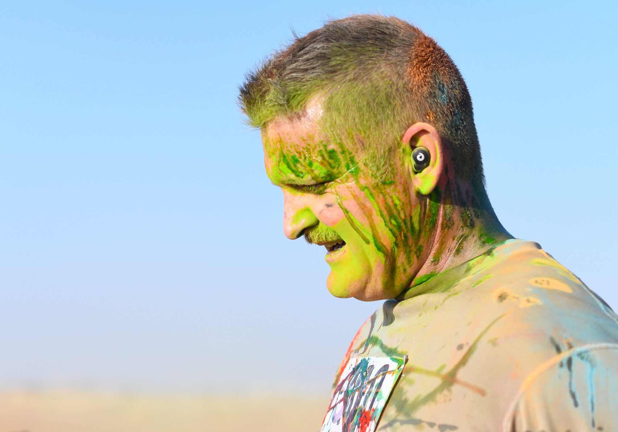 A color run participant finishes the race at Nigerien Air Base 201, Niger, Feb. 2, 2020. More than 30 runners and volunteers participated in the event. (U.S. Air Force photo by Tech. Sgt. Alex Fox Echols III)