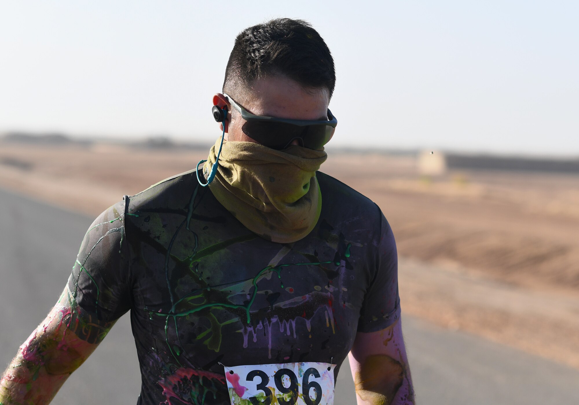 A color run participant finishes the race at Nigerien Air Base 201, Niger, Feb. 2, 2020. More than 30 runners and volunteers participated in the event. (U.S. Air Force photo by Tech. Sgt. Alex Fox Echols III)