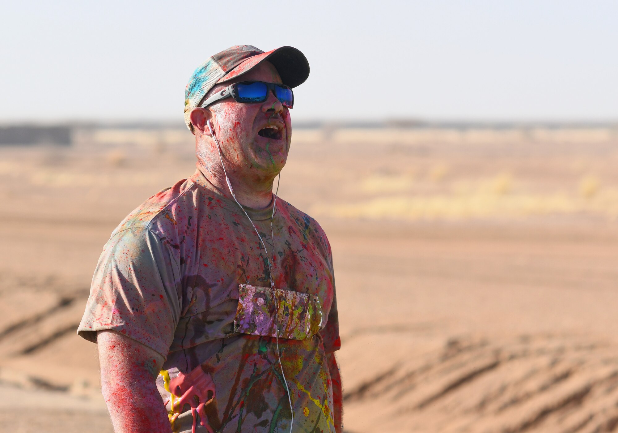 A color run participant finishes the race at Nigerien Air Base 201, Niger, Feb. 2, 2020. More than 30 runners and volunteers participated in the event. (U.S. Air Force photo by Tech. Sgt. Alex Fox Echols III)