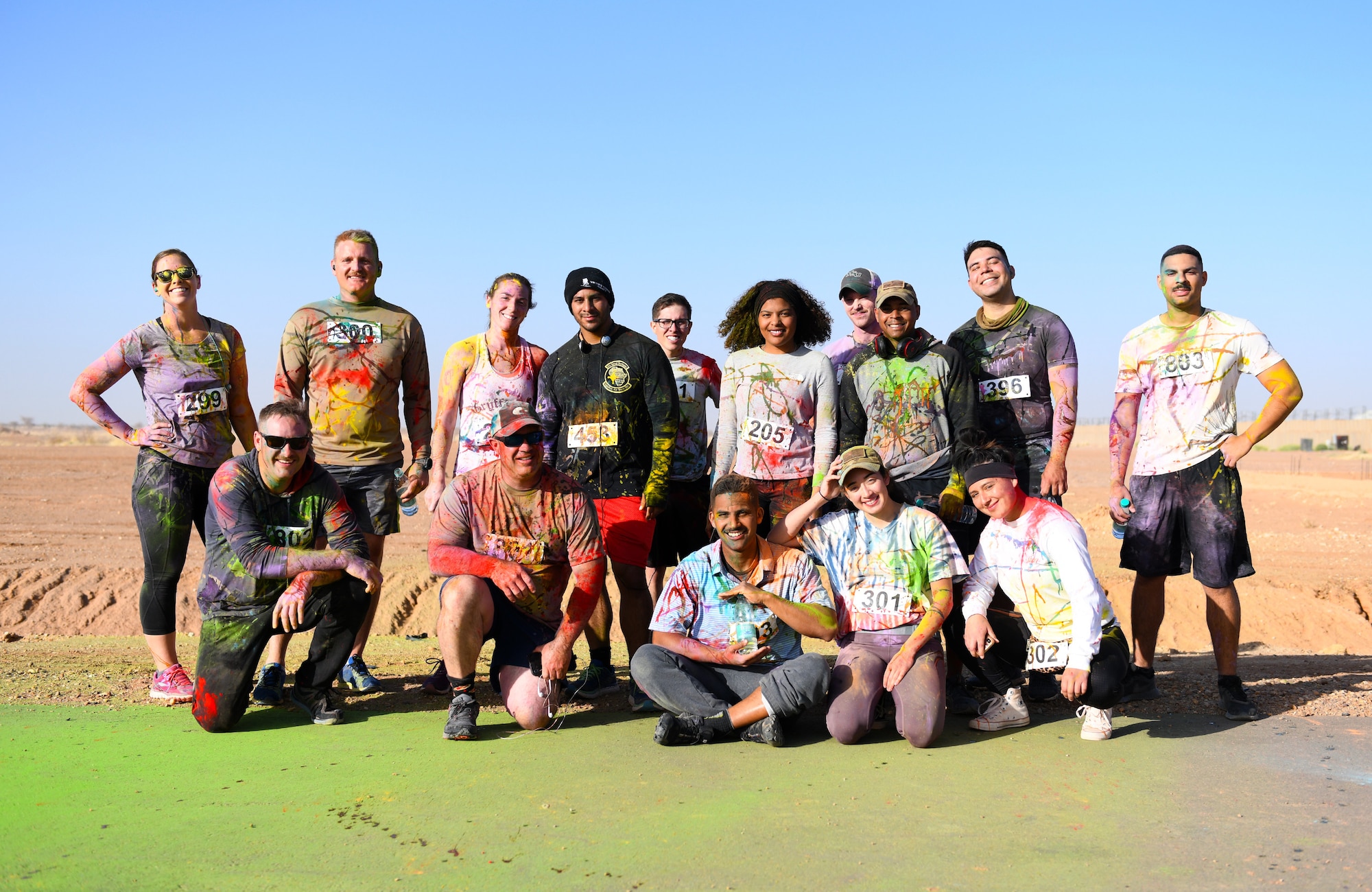 Color run participants pose for a photo after completing the event at Nigerien Air Base 201, Niger, Feb. 2, 2020. More than 30 runners and volunteers participated in the event. (U.S. Air Force photo by Tech. Sgt. Alex Fox Echols III)