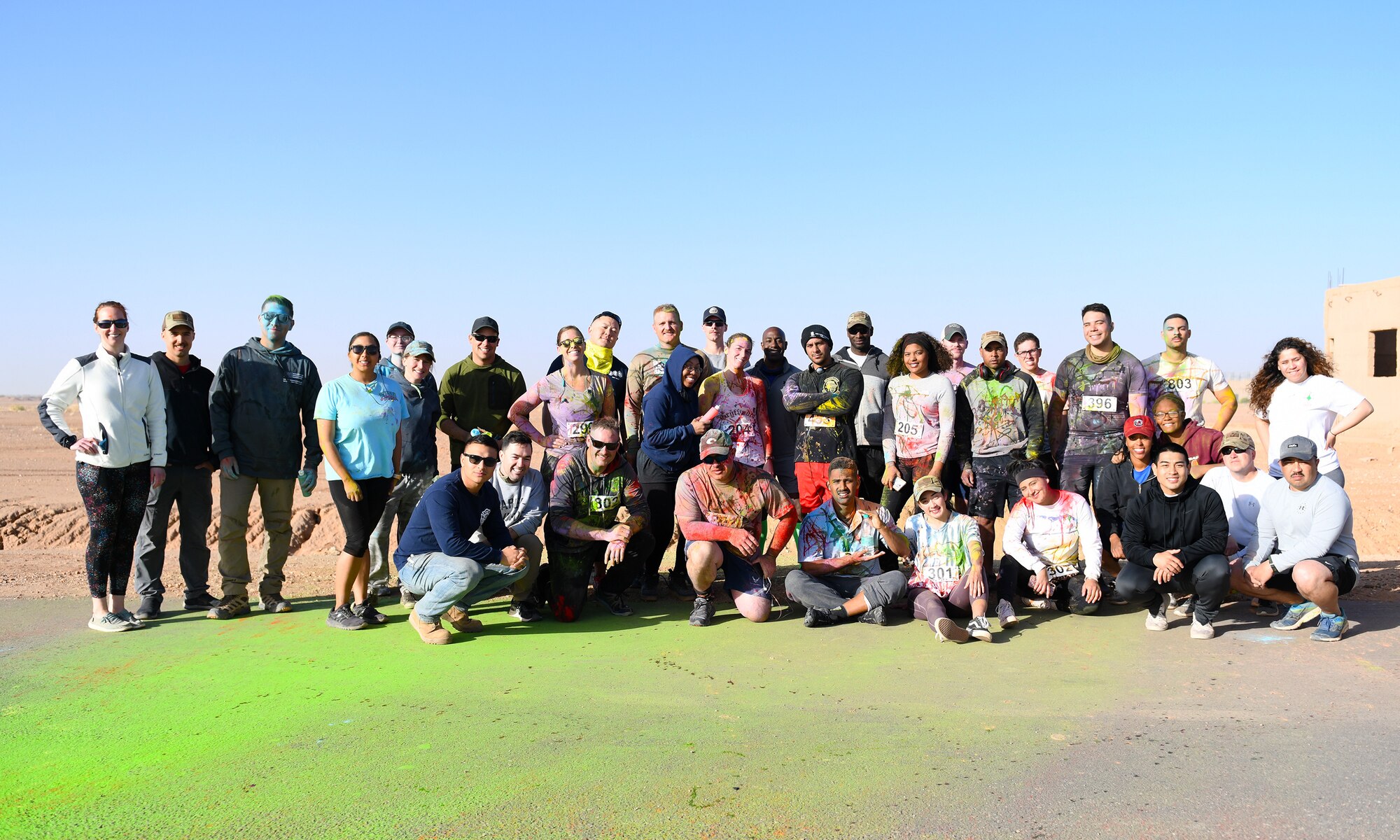 Color run participants and volunteers pose for a photo after the conclusion of the event at Nigerien Air Base 201, Niger, Feb. 2, 2020. More than 30 runners and volunteers participated in the event. (U.S. Air Force photo by Tech. Sgt. Alex Fox Echols III)