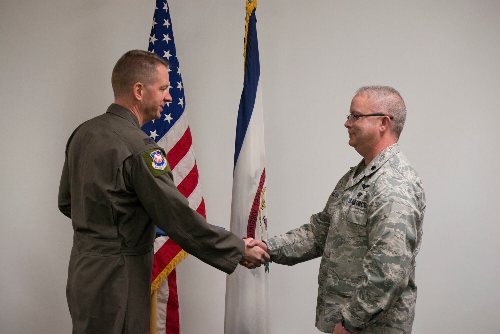 Col. Marty Timko, 167th Airlift Wing commander, congratulates Lt. Col. Charles Nasser during a ceremony marking Nasser’s assumption of command of the 167th Mission Support Group, Feb. 1, 2020.