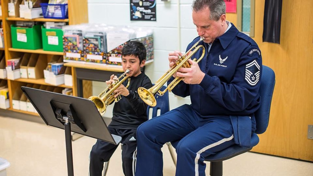 For the entire school year our Advancing Innovation through Music (AIM) program supported local educational outreach program Bridges: Harmony Through Music.  We were honored to be presented the Community Partner of the Year award by founding director Bonny Tynch.  Pictured is Senior Master Sgt. Kevin Burns working with a young trumpet student at a Bridges event.  (U.S. Air Force Photo/released)