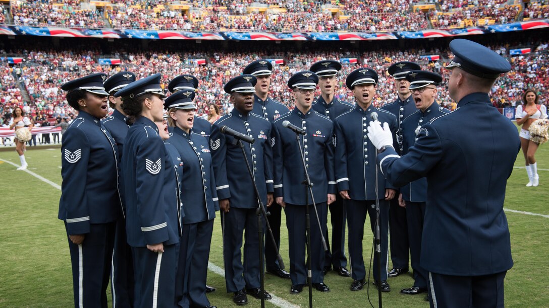 Members of the Singing Sergeants, conducted by Capt. Dustin Doyle perform the National Anthem prior to a Washington Redskins game at FedEx Field in 2017 (U.S. Air Force Photo by CMSgt Bob Kamholz/Released)