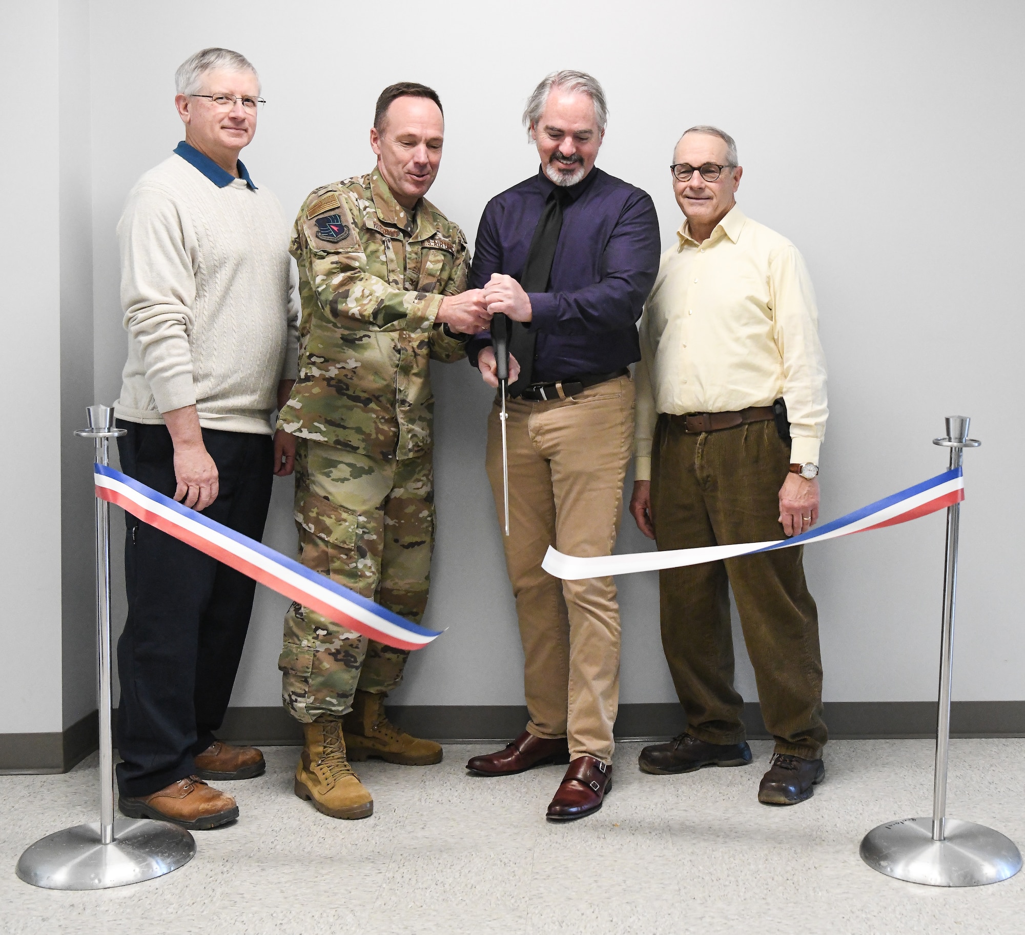 Air Force project manager Tony Pennington, second from right, and Col. Charles Roberts, Test Support Division chief, cut a ribbon, Jan. 6, to celebrate the renovation of the Civil Engineering, Operations and Maintenance Building at Arnold Air Force Base, Tenn. Also pictured are Jerry Goodman, left, a project manager with the Test Operations and Sustainment (TOS) contract, and Barry Banks, a construction superintendent with TOS. (U.S. Air Force photo by Jill Pickett)