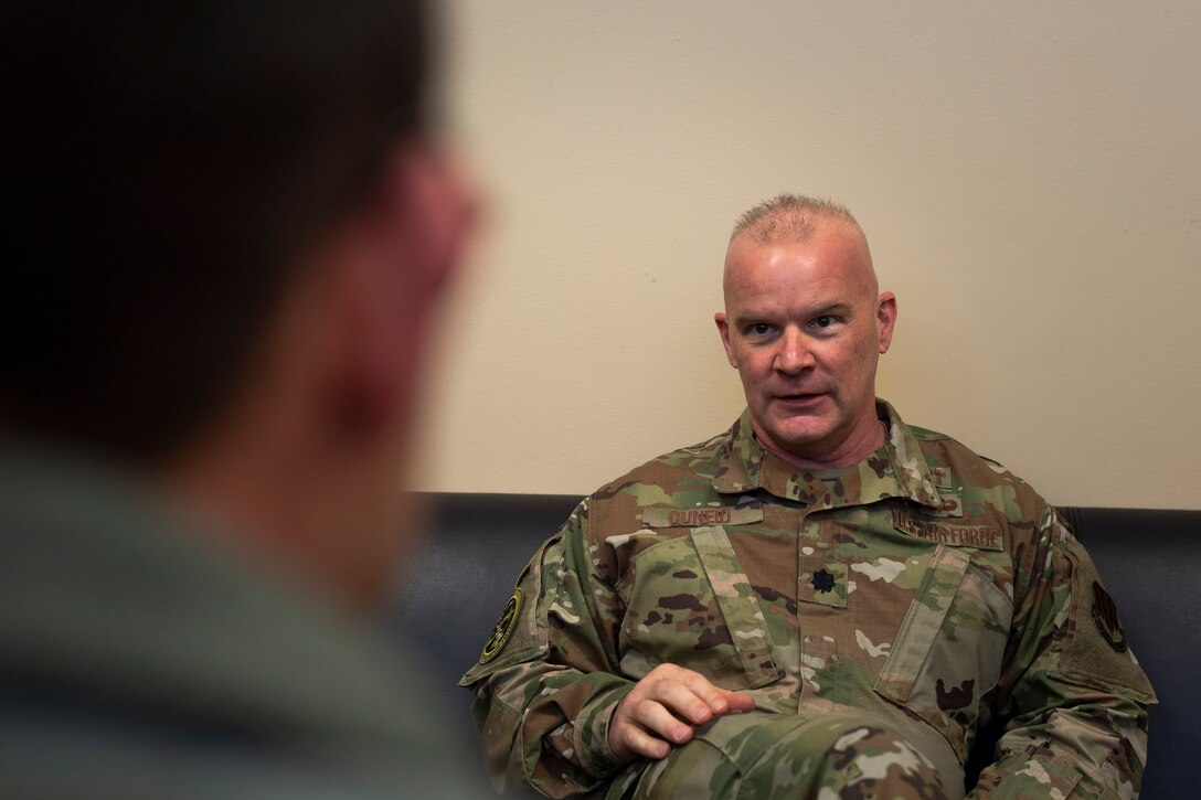 A photo of the wing's chaplain speaking with an Airman