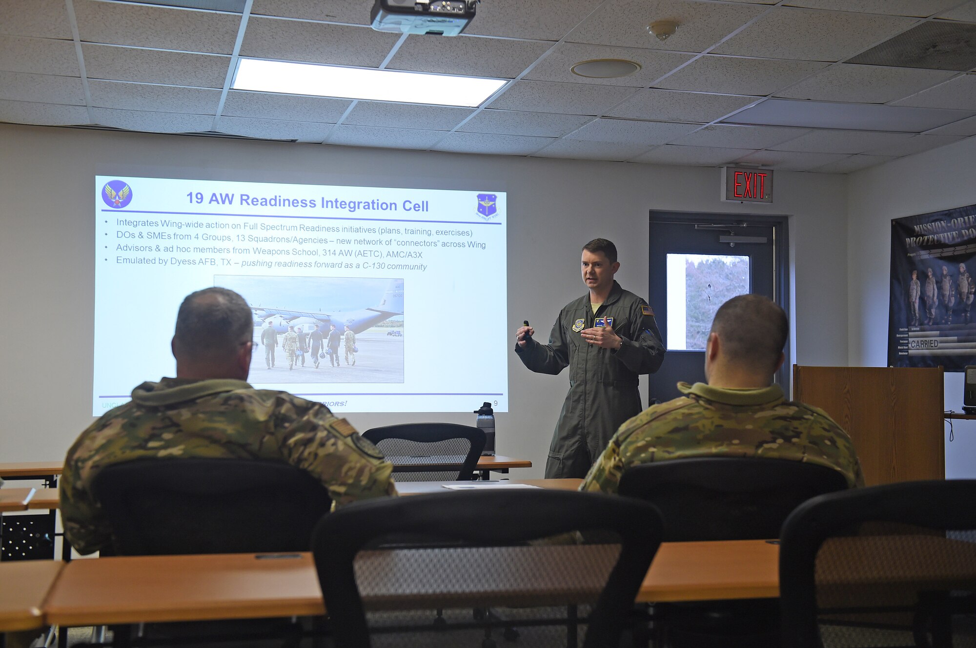 Airmen receive a briefing by PowerPoint