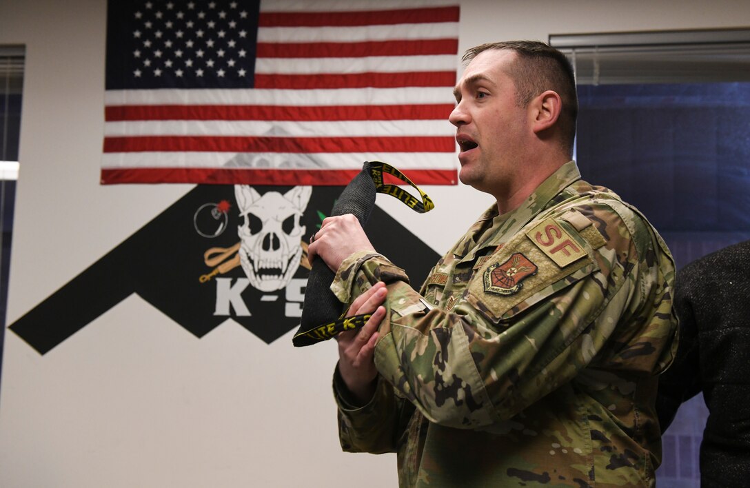 U.S. Air Force Tech. Sgt. Kyle Tredway, the 509th Security Forces Squadron military working dog kennel master, talks about various grip strengths of MWDs to Warrensburg High School students during a 2020 Community Leadership and Involvement Means a Better Community High (CLIMB High) tour at Whiteman Air Force Base, Jan. 29, 2020. MWD handlers showed students kennels and the different command abilities the dogs can execute for a mission. (U.S. Air Force photo by Staff Sgt. Sadie Colbert)