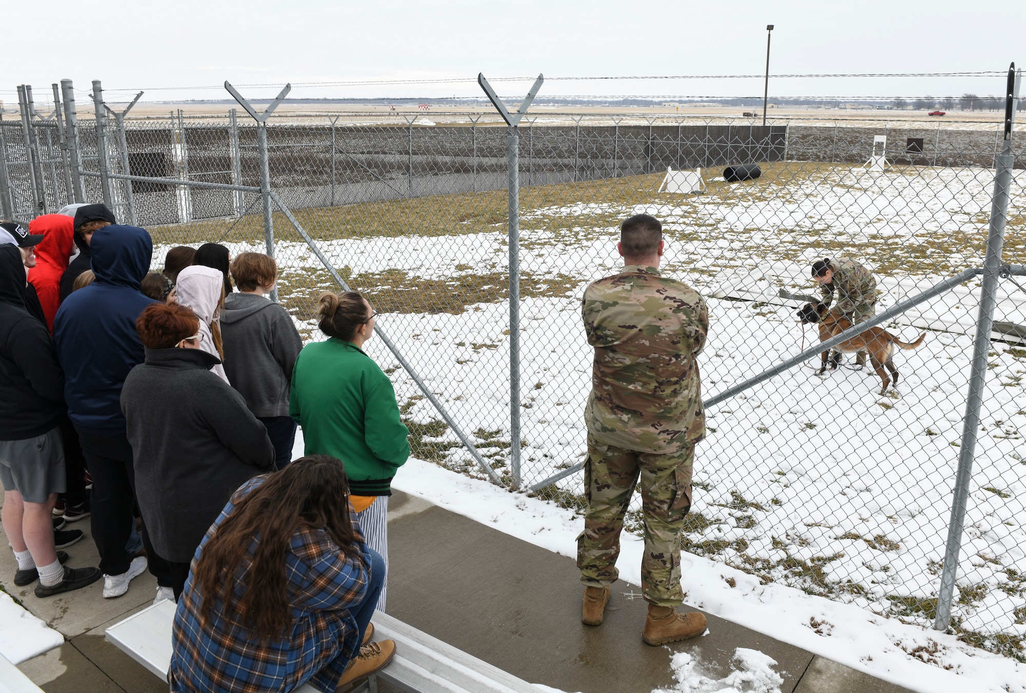 Warrensburg High School students watch U.S. Air Force Staff Sgt. Ashley Christenson, a 509th Security Forces Squadron military working dog handler, perform demonstrations with her MWD, Aci, at Whiteman Air Force Base, Jan. 29, 2020. The students visited Whiteman AFB as part of the 2020 Community Leadership and Involvement Means a Better Community High School program. CLIMB High is a youth leadership program in Johnson County, Mo., for students interested in developing leadership skills and learning more about their communities. (U.S. Air Force photo by Staff Sgt. Sadie Colbert)