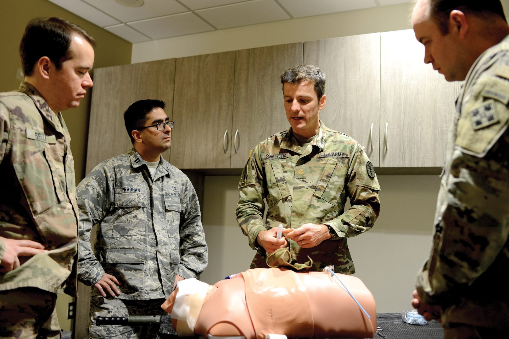 Army Maj. Michal Sobieszczyk demonstrates how to perform a cricothyrotomy Jan. 14 for doctors with 4th Infantry Division and the U.S. Air Force Academy at Evans Army Community Hospital’s new medical simulation lab. Sobieszczyk is a pulmonary/critical care doctor who provided joint education with his critical-care mobile training team assigned to Brooke Army Medical Center at Joint Base San Antonio-Fort Sam Houston.