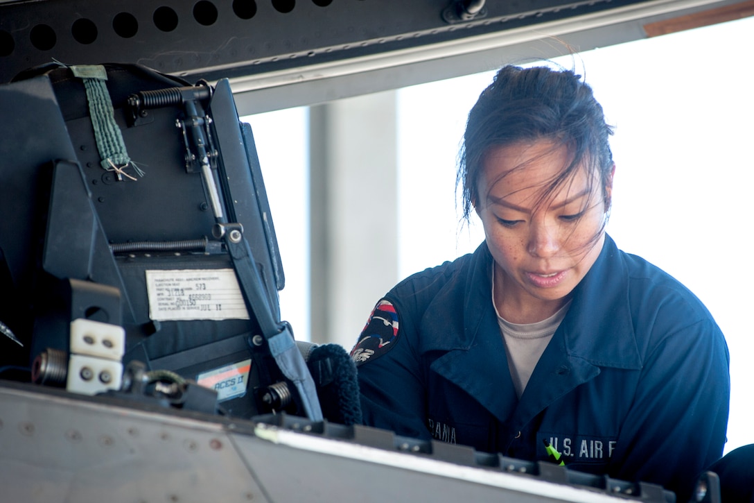 An airman services an aircraft.