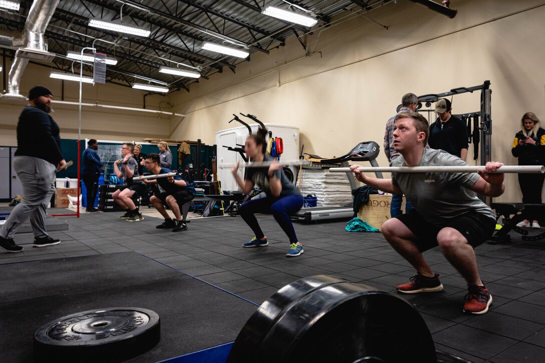 A group of volunteers stretch before participating in a human performance baseline test on Cannon Air Force Base, N.M., Jan. 30, 2020. The human performance baseline test is an Air Force Special Operations Command pilot test to determine the effectiveness of the new human performance program. (U.S. Air Force photo by Senior Airman Candin Muniz)