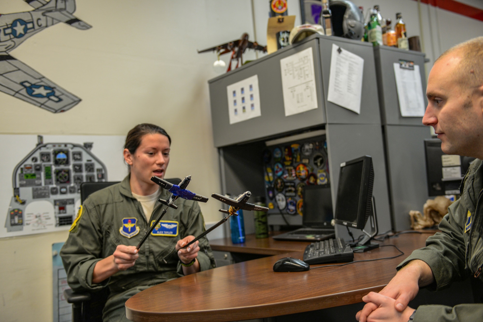 First Lt. Alexandra Taylor, 37th Flying Training Wing T-6 instructor pilot, discusses formation flying with Capt. James Tillinger, 37th FTS member, Jan. 27, 2020, at Columbus Air Force Base, Mississippi. Prior to becoming an IP, Taylor was a graduate of Specialized Undergraduate Pilot Training at Columbus AFB. (U.S. Air Force photo by Airman Davis Donaldson)