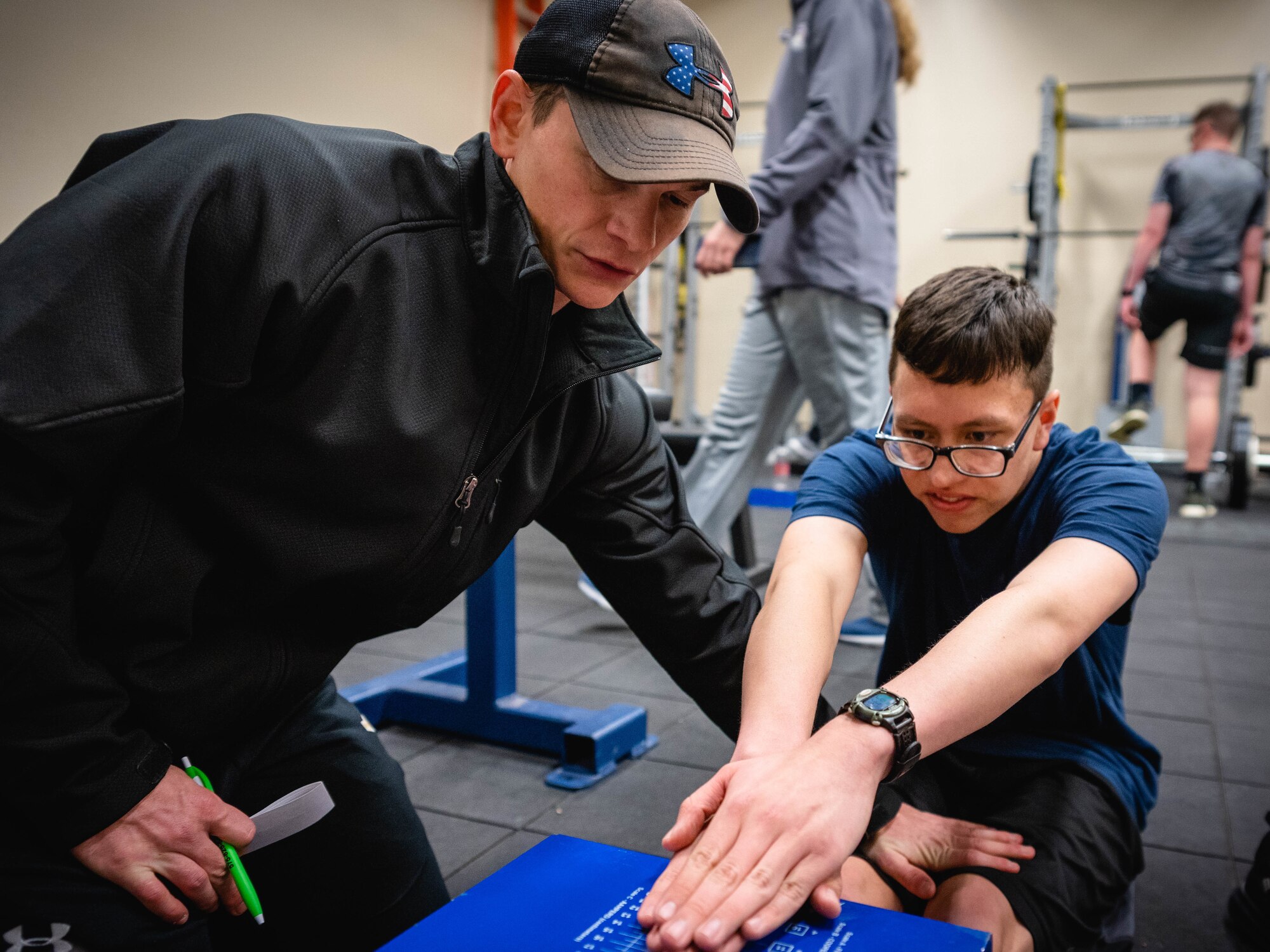 Chase Chesterman, 27th Special Operations Group Preservation of the Force and Families human performance dietician, measures the flexibility of a volunteer at a human performance baseline test on Cannon Air Force Base, N.M., Jan. 30, 2020. The human performance baseline test is an Air Force Special Operations Command pilot test to determine the effectiveness of the new human performance program. (U.S. Air Force photo by Senior Airman Candin Muniz)