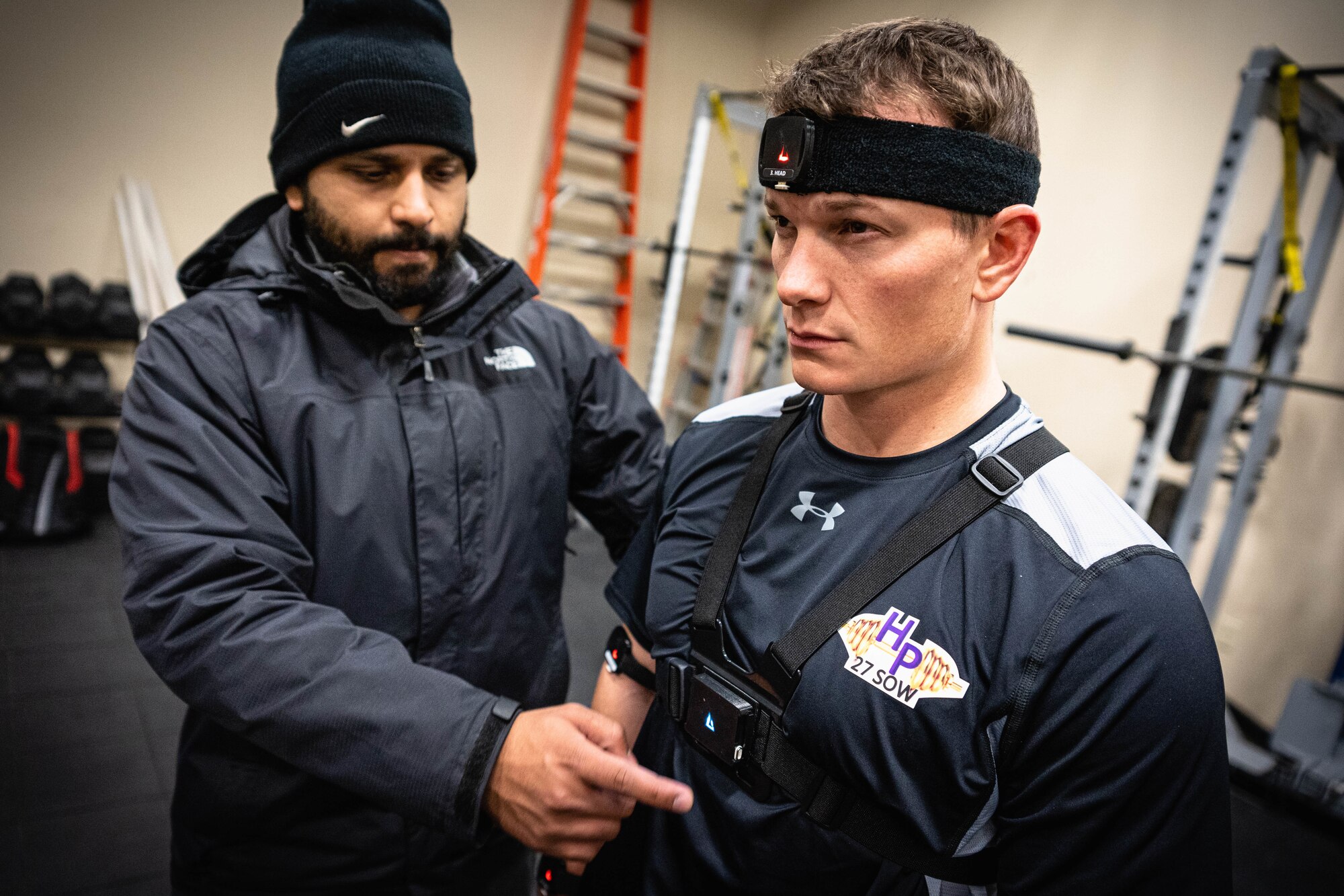 Karan Kanchan, Equilibrium by Vayu Tech founder and inventor, attaches a sensor to a volunteer at a human performance baseline test on Cannon Air Force Base, N.M., Jan. 30, 2020. The sensor allows researchers to detect weak areas in an airman's mobility during a human performance baseline test. The human performance baseline test is an Air Force Special Operations Command pilot test to determine the effectiveness of the new human performance program. (U.S. Air Force photo by Senior Airman Candin Muniz)