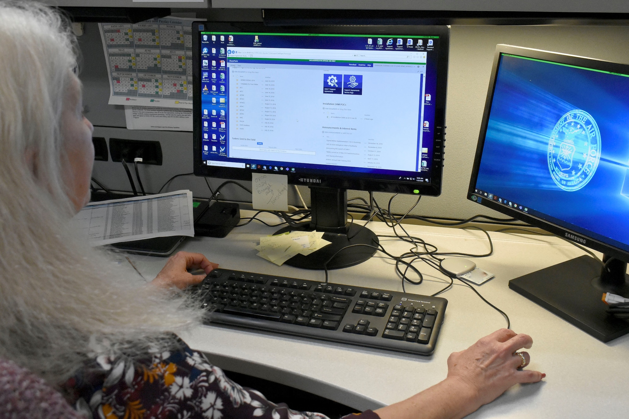 Donna Johnson, AFIMSC support agreement manager, reviews documents loaded into the Support Agreements Management Tool, or SAM-T.