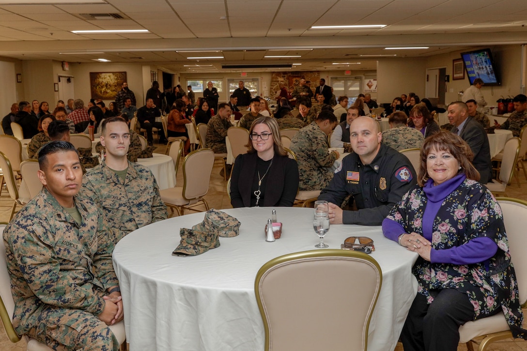 Awardees (from left to right) Sgt. Jeffrey Xochicale, Noncommissioned Officer of the Year, Lance Cpl. Noah Avila, Marine of the Year, Reah Andrews, Employee of the Quarter, Ryan Tworek, Supervisor of the Year, and Ruby Adams, Employee of the Quarter, sit together before the quarterly awards breakfast begins aboard Marine Corps Logistics Base Barstow, Calif., Jan. 28. (U.S. Marine Corps photo by Jack J. Adamyk)