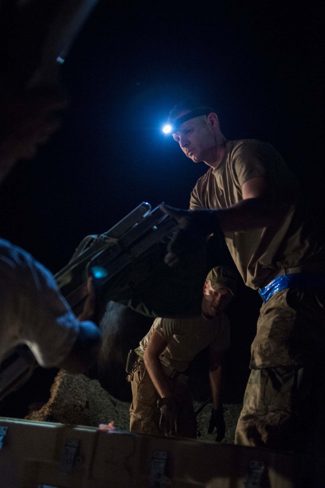 Airmen from the 621st Contingency Response Group pack supplies onto a pallet in preparation to redeploy at Prince Sultan Air Base, Kingdom of Saudi Arabia, July 27, 2019. Most construction and deconstruction operations take place at night to avoid heat-related complications. The 621st CRG deployed for an air base opening mission in response to the White House authorization of approximately 1,000 additional troops in U.S. Central Command's area of responsibility for defensive purposes to address air, naval, and ground-based threats in the Middle East. (U.S. Air Force photo by Staff Sgt. Sarah Brice)
