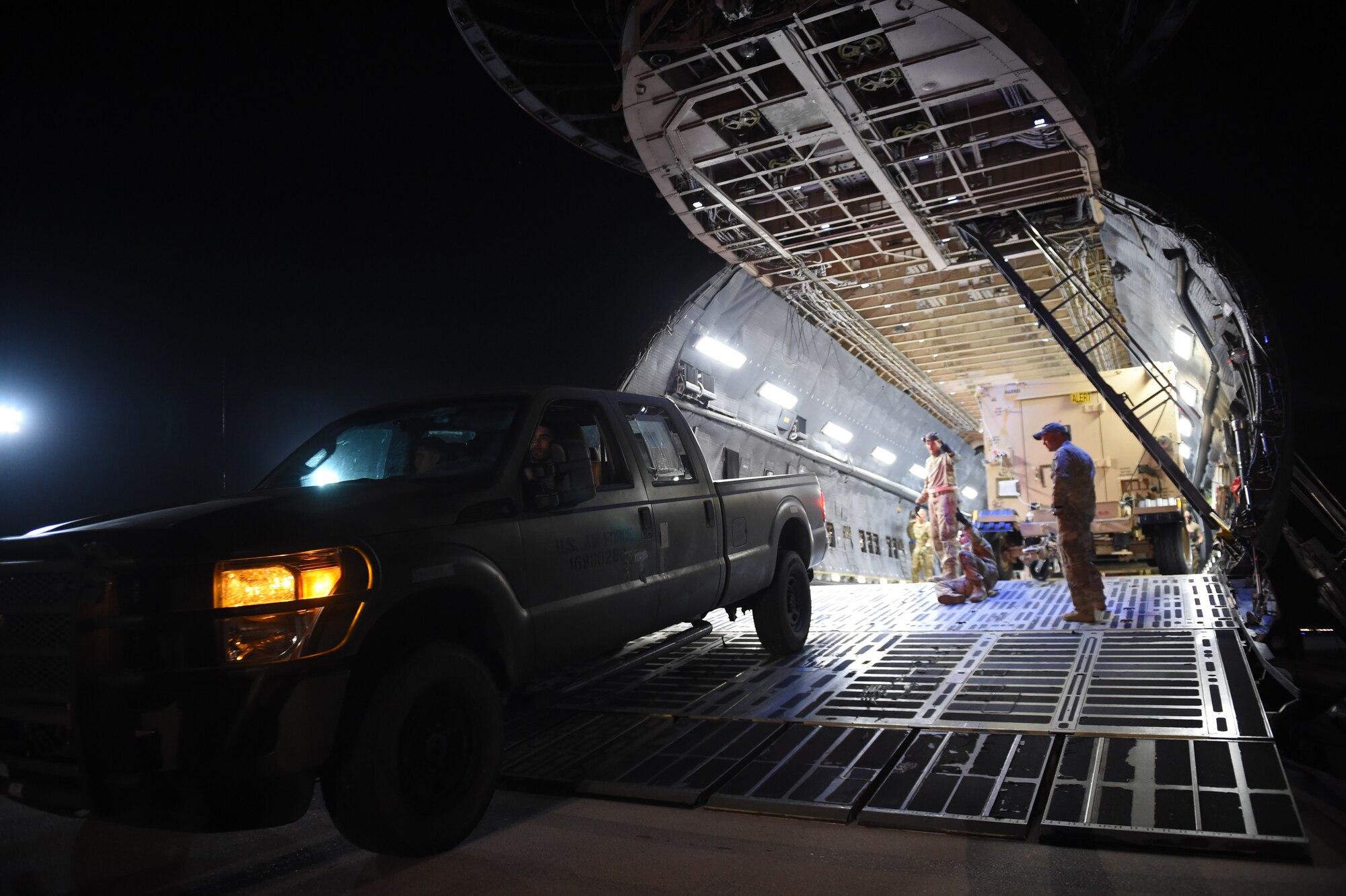 Airmen from the 621st Contingency Response Group help offload equipment from a C-5M Super Galaxy at Prince Sultan Air Base, Kingdom of Saudi Arabia, June 26, 2019. The 621st CRG deployed for an air base opening mission in response to the White House authorization of approximately 1,000 additional troops in U.S. Central Command's area of responsibility for defensive purposes to address air, naval, and ground-based threats in the Middle East. (U.S. Air Force photo by Staff Sgt. Sarah Brice)