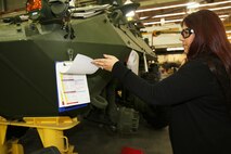 Angelina Rivera, Prouction Analysis Branch head, displays one of the tracking logs used to ensure that each vehicle worked on at Production Plant Barstow, Marine Depot Maintenance Command, is tracked from start to finish, through every step of tear down, repair and rebuild, on the Yermo Annex aboard Marine Corps Logistics Base Barstow, Calif., Jan. 15.