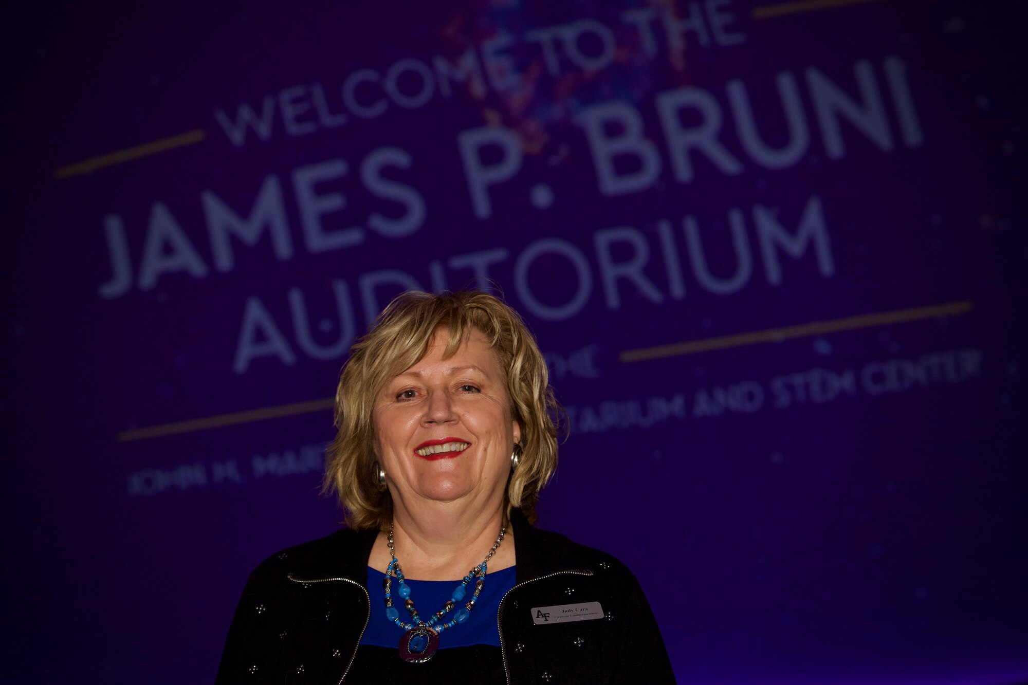 Judy Cara, the planetarium and STEM center project manager, poses for a photo before showing “Dream Big: Engineering our World” at the Air Force Academy, Colo., Feb. 3, 2020. Cara encourages regional students to embrace STEM in their education paths. So far, eight schools have brought 444 students to see the Dream Big program and in 2019, the planetarium hosted 135 school groups totaling 1,842 students. (U.S. Air Force photo by Tech. Sgt. Benjamin W. Stratton)